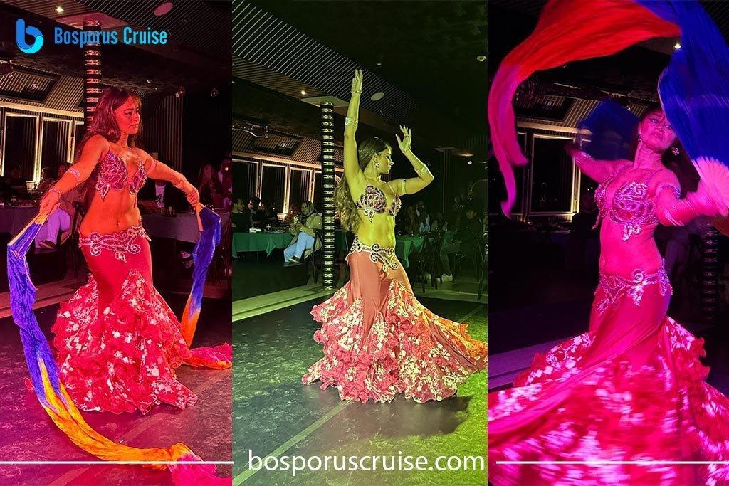 Tre danzatrici dello spettacolo orientale in costumi di paillettes sotto le luci di scena su una crociera con cena sul Bosforo
