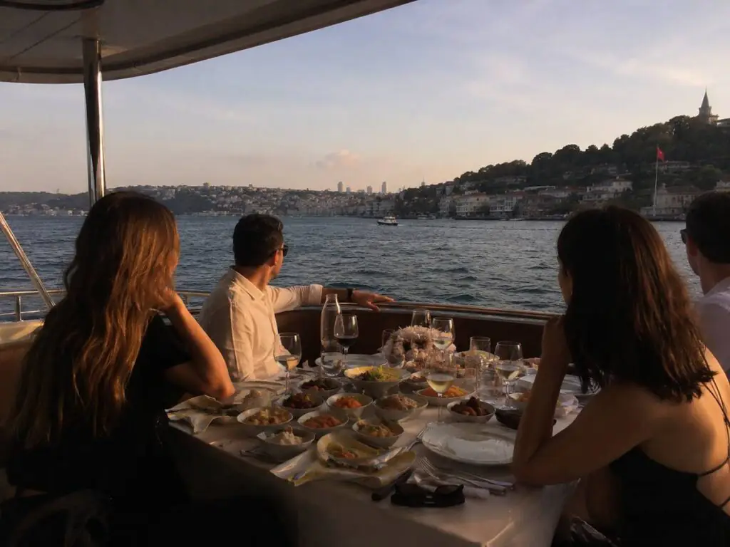 Guests enjoying meze at a private table on the Bosphorus dinner cruise in Istanbul